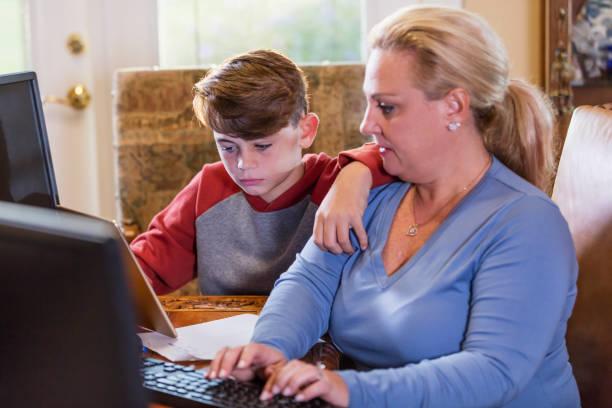 istock Hispanic mother and son working, studying at home 1277864542