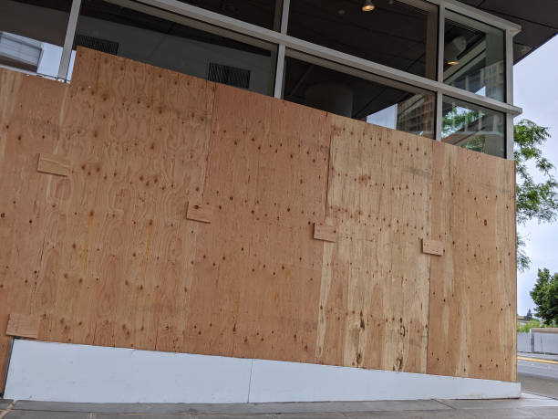 istock boarded up windows and doors in a downtown building during protests and riots 1277869334