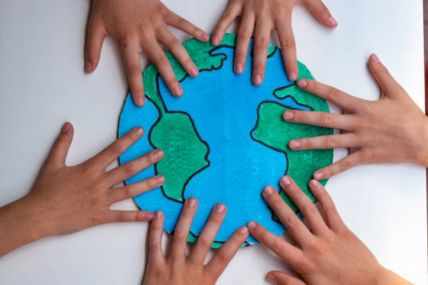 istock Children hands guarding planet Earth 1277874395