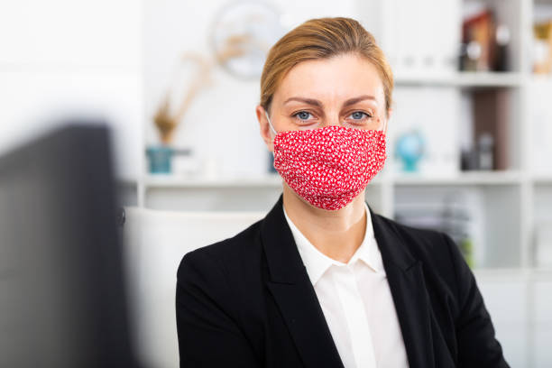 istock Woman manager in medical mask in office while working day 1277876743