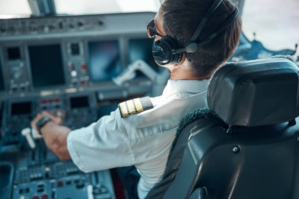 istock Male pilot flying passenger plane on sunny day 1277876802