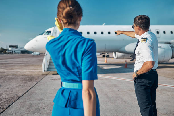 istock Crew of passenger plane standing on runway 1277876812