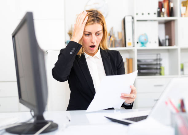 istock Worried young woman manager working at laptop with documents 1277876870