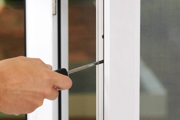 istock handyman adjusting white pvc plastic window indoors. worker using screwdriver to repair upvc window. homework maintenance 1277880644