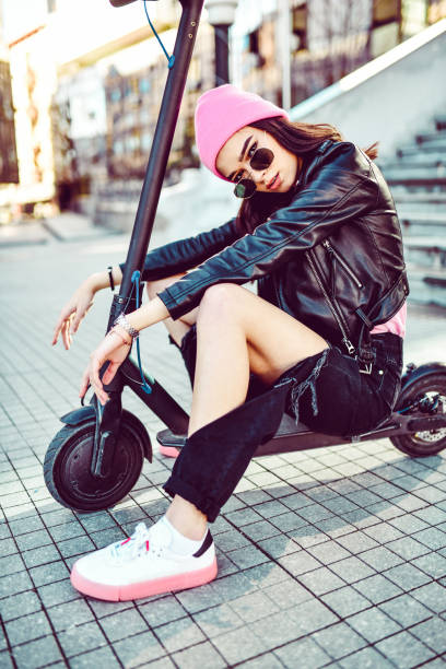 istock Modern Female Sitting On Electric Scooter Outside 1277881491