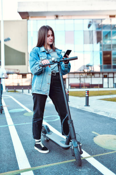 istock Female Checking Social Media On Smartphone While Riding Electric Scooter 1277881583