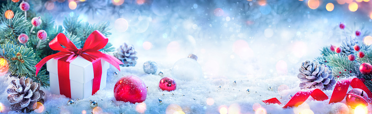Gift Box And Baubles On Snowy Background