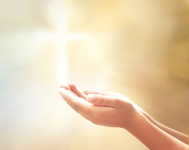 Worship God concept Prayer open empty hands with palm up over blurred cross with golden light background easter sunday photos stock pictures, royalty-free photos & images