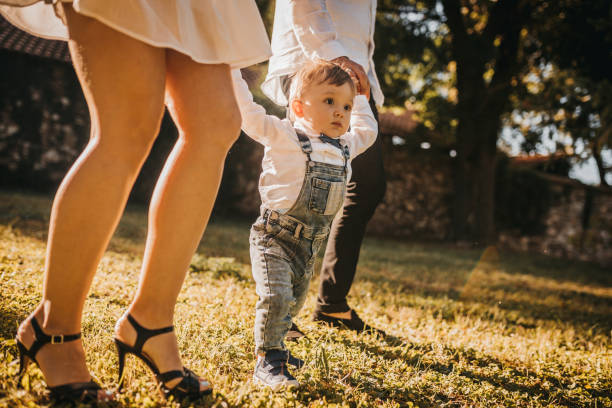 istock Happy family sitting on the grass 1277887687