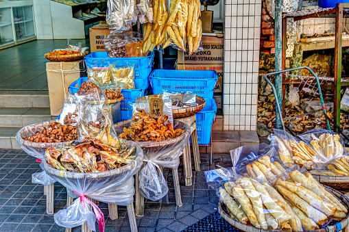 Lantau, Hong Kong - January 3, 2020: Vendors along the narrow streets of Tai O fishing village selling dried fish and assorted foods in the Tao O fishing village on Lantau Island in Hong Kong