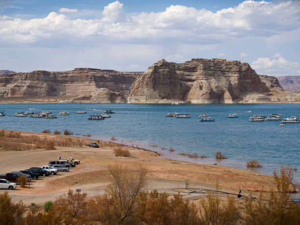 Lake Powell is a man-made reservoir on the Colorado River, between Utah and Arizona It is the second largest man-made reservoir in the United States behind Lake Mead, storing 24,322,000 acre feet of water when full. Lake Powell was created by the flooding of Glen Canyon by the controversial Glen Canyon Dam, which also led to the creation of Glen Canyon National Recreation Area, a popular summer destination page arizona stock pictures, royalty-free photos & images