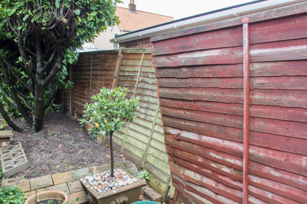 istock Wind damaged garden fence panels. Broken lap wood panel blown over. 1277899940