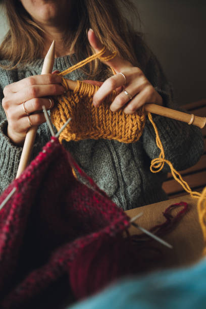istock Close up on woman's hands knitting 1277911288