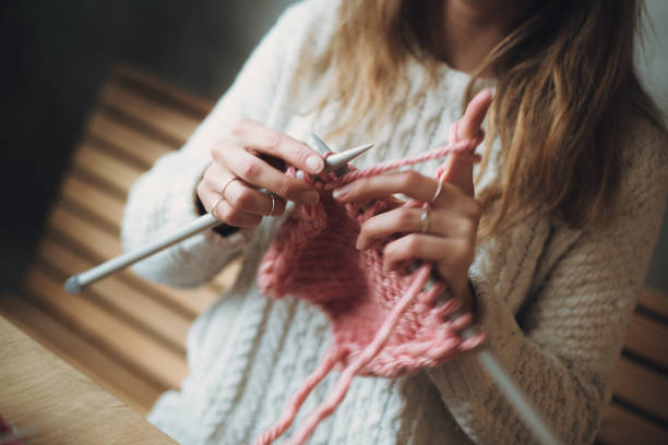 istock Close up on woman's hands knitting 1277911289