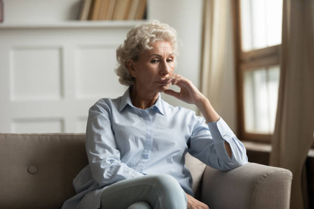 istock Sad unhappy middle aged female sitting on couch at home 1277914085