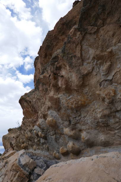 istock High angle view up rough rocky cliffside and some sky visible 1277917420