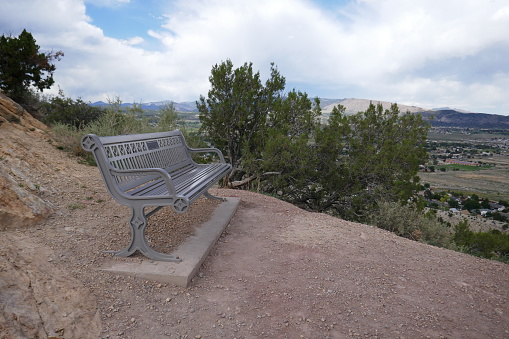 Park bench overlooking scenic valley view from mountain