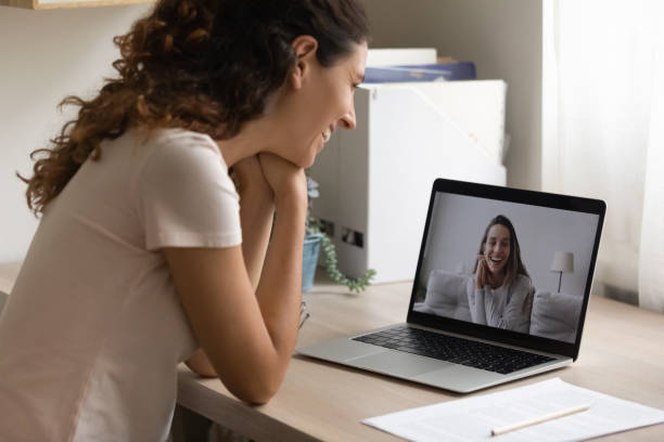 istock Smiling young woman have webcam talk with friend 1277917693