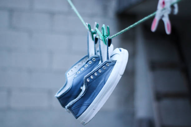 istock Old tennis shoes drying outside 1277918015