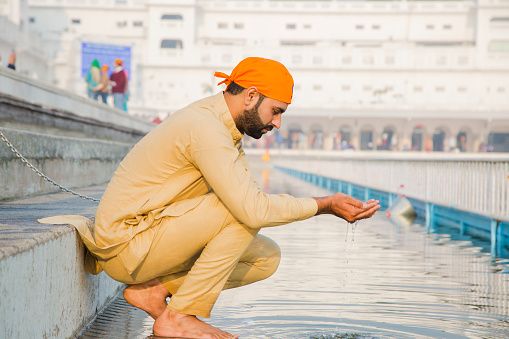 Amritsar, India - sep 26, 2014 : Unidentified Sikh man visiting the Golden Temple in Amritsar, Punjab, India. Sikh pilgrims travel from all over India to pray at this holy site.