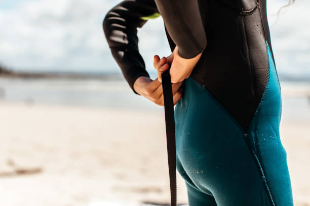 istock Young girl in a wetsuit on the beach 1277925199