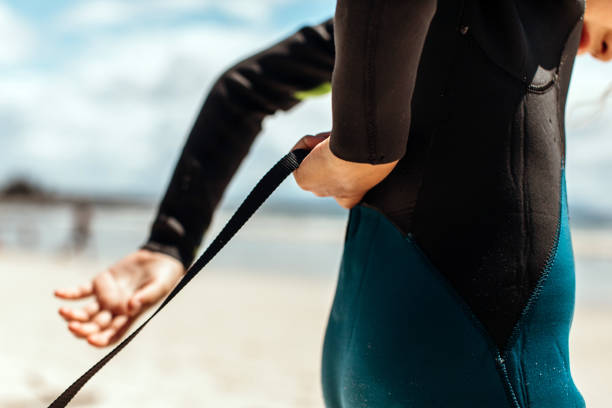 Young girl in a wetsuit on the beach