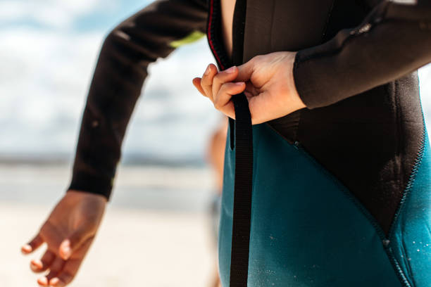 istock Young girl in a wetsuit on the beach 1277925251