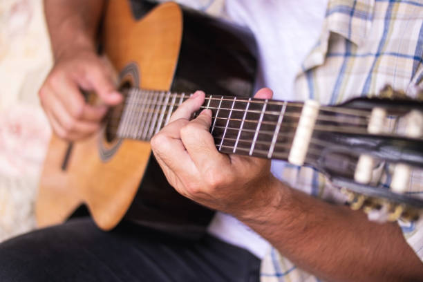 istock Young man playing guitar in a rural place. 1277925840