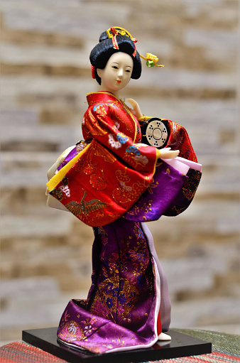 A beautiful japanese geisha porcelain doll dancer