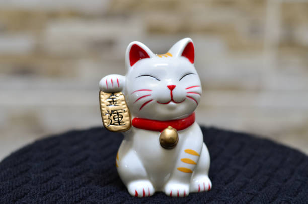 istock Smiling maneki neko holding koban 1277927280
