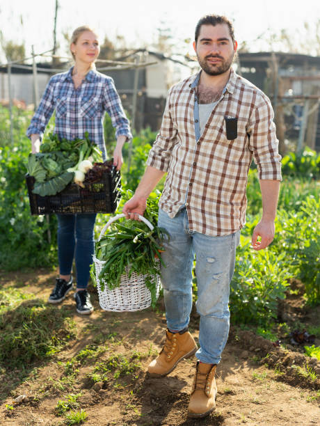 istock Gardeners posing with vegetables harvest 1277930963