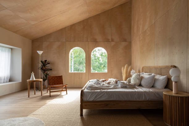 istock Stylish Bedroom corner with rattan headboard and bed with soft pillows setting with white pillows plywood wall on the background / cozy interior design / modern interior 1277932950