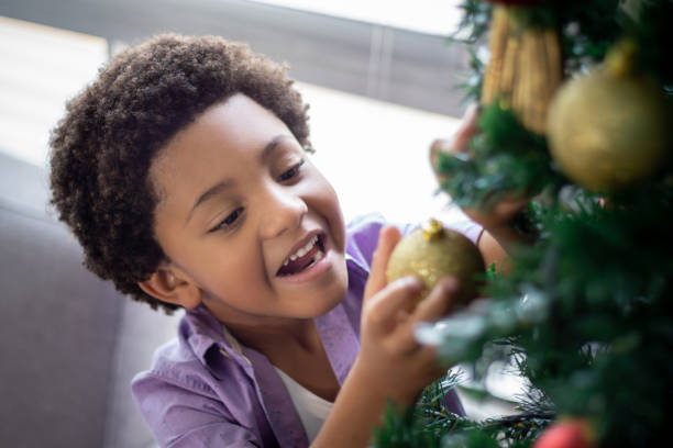 istock Happy boy decorating the Christmas tree 1277934052