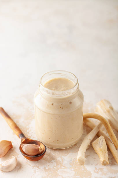 istock Horseradish sauce in a jar and ingredients on a white background. 1277937294