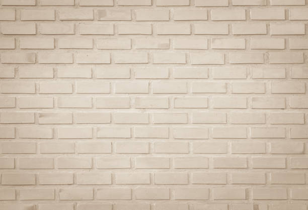 istock Empty Background of wide cream brick wall texture. Old brown brick wall concrete or stone pattern nature, wallpaper limestone abstract floor/Grid uneven interior rock. Home & office design backdrop. 1277942318