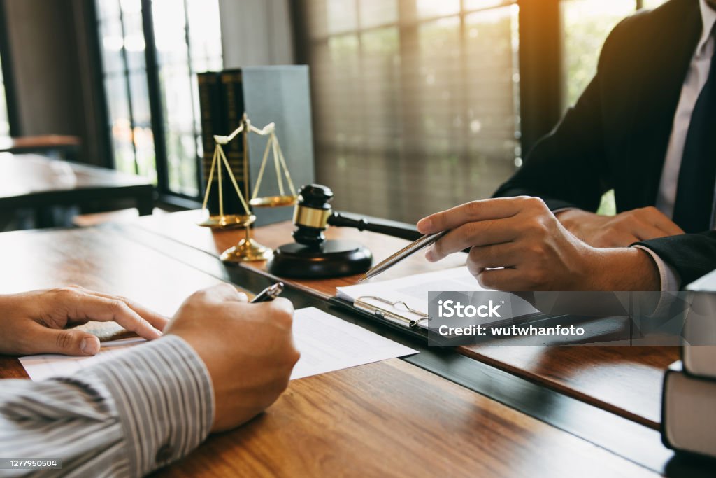 Lawyer is explaining about the wrongdoing laws regarding fraud to the client at the office. Law Stock Photo