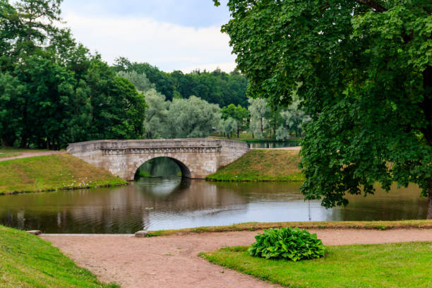 istock Stone arch bridge across a lake in Gatchina, Russia 1277953884