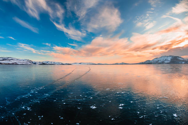 istock Ice on the frozen lake at sunset. 1277954443