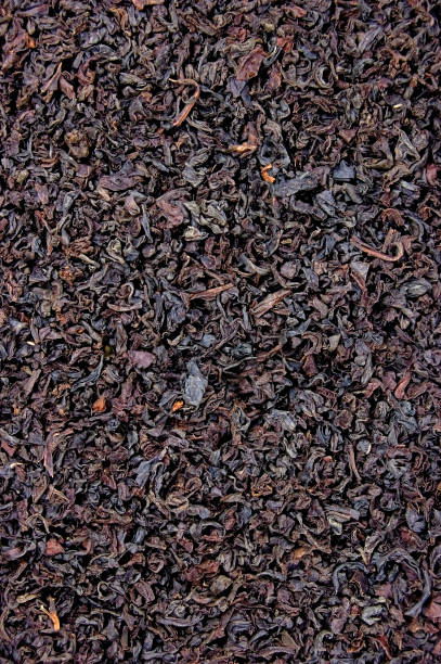 istock Detailed Black Tea Loose Leaf Texture Pattern, Vertical Textured Macro Closeup Background Copy Space 1277958367
