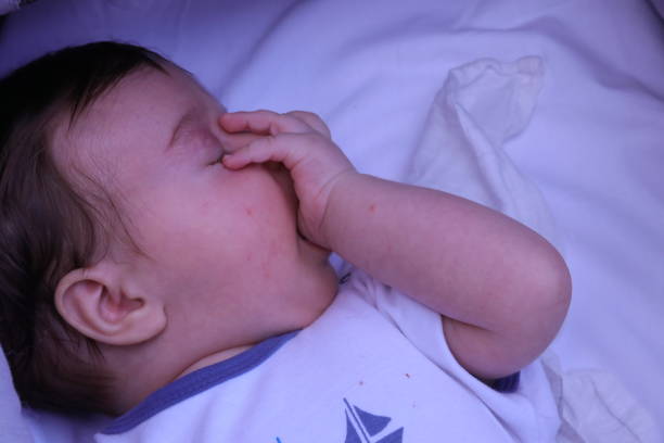 cute baby boy sucking his finger - thumb sucking cute small lying down imagens e fotografias de stock