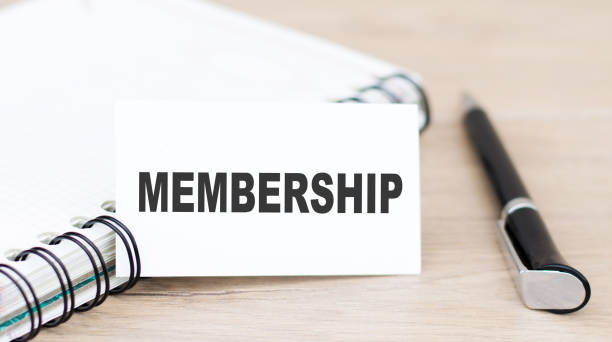 istock membership. text on a card next to a notebook and a pen on the table 1277961414