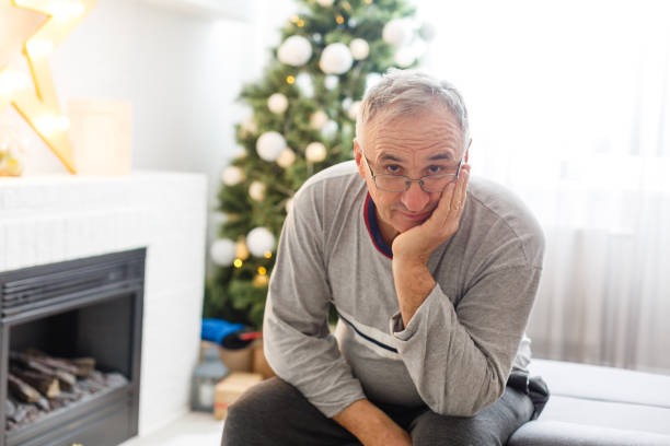 istock A senior man sitting by the fireplace at christmas 1277961457