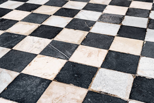 istock Black and white checkerboard tiles, old with scratches and scuffs. 1277962367