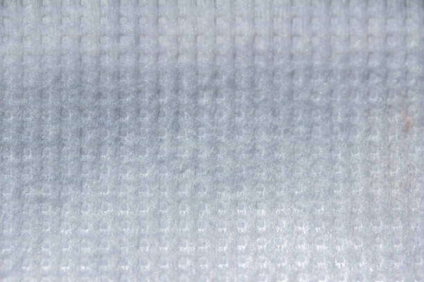 Full frame macro abstract background view of white cotton medical fabric texture, with copy space.