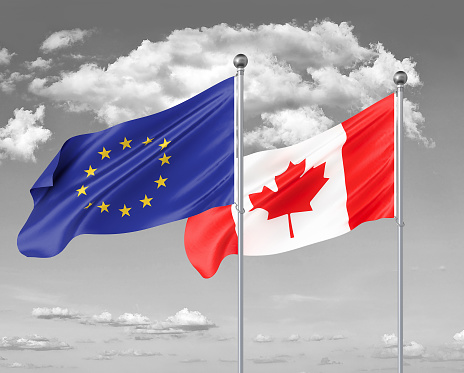 Two realistic flags. European Union vs Canada. Thick colored silky flags of European Union and Canada. 3D illustration on sky background. - Illustration