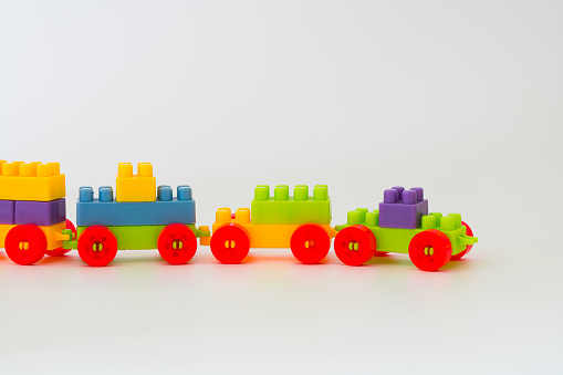 The little train is built with rainbow toy bricks. Children's educational toys