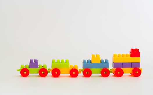 Colored wooden toy train on white background.