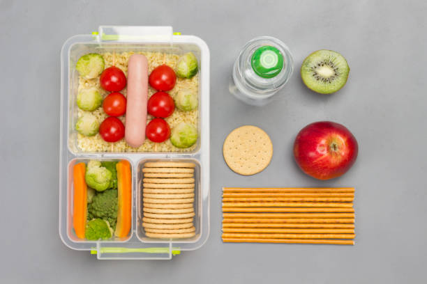 istock Lunch box with sausage, broccoli and tomatoes. 1277971716