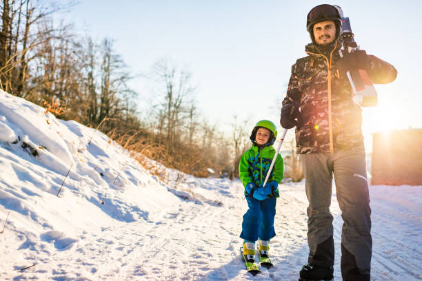 istock Beautiful smiling father and son on skiing 1277974753