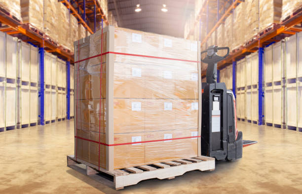 istock Cargo shipment boxes, Warehousing, Large pallet goods and electric forklift pallet jack at the warehouse storage. 1277975509
